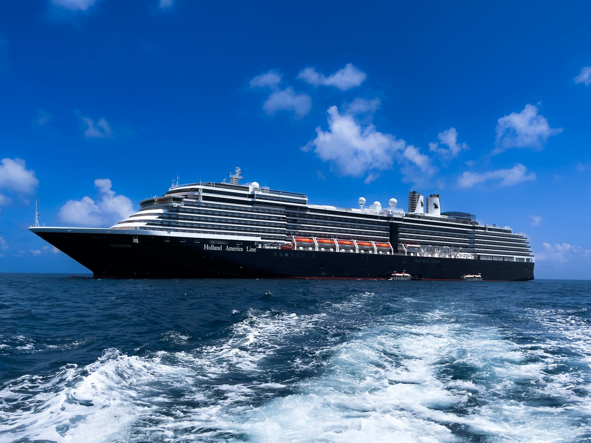 A Holland America cruise ship sails in the ocean
