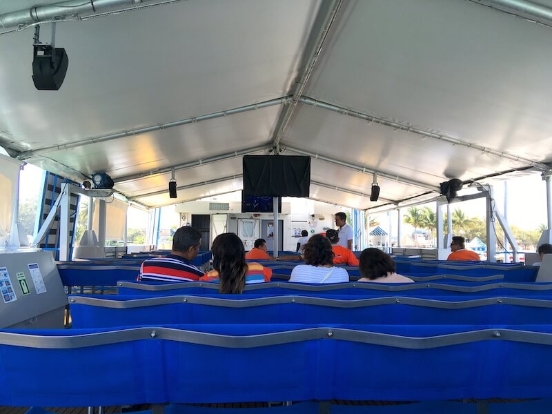 blue seats onboard ferry with passengers