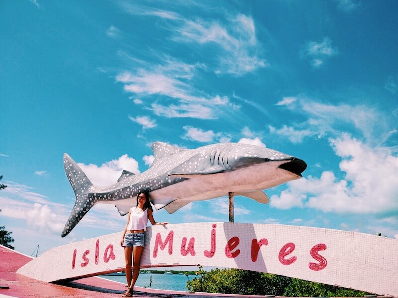 large fish statue and city sign