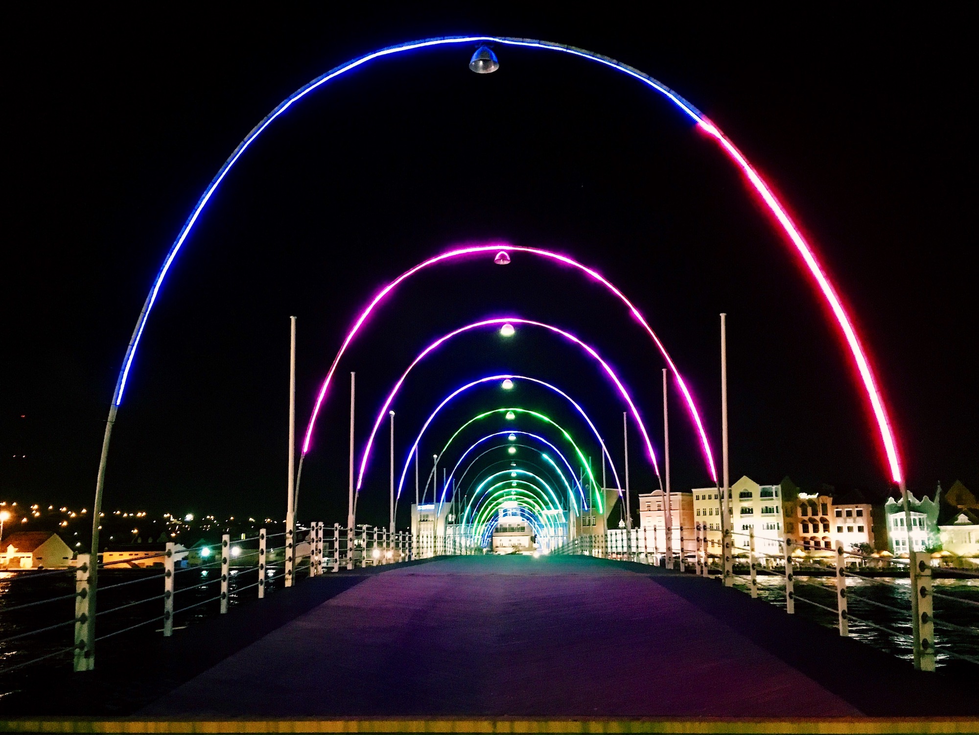 Colorfully lit up arches of Queen Emma Bridge in Curacao
