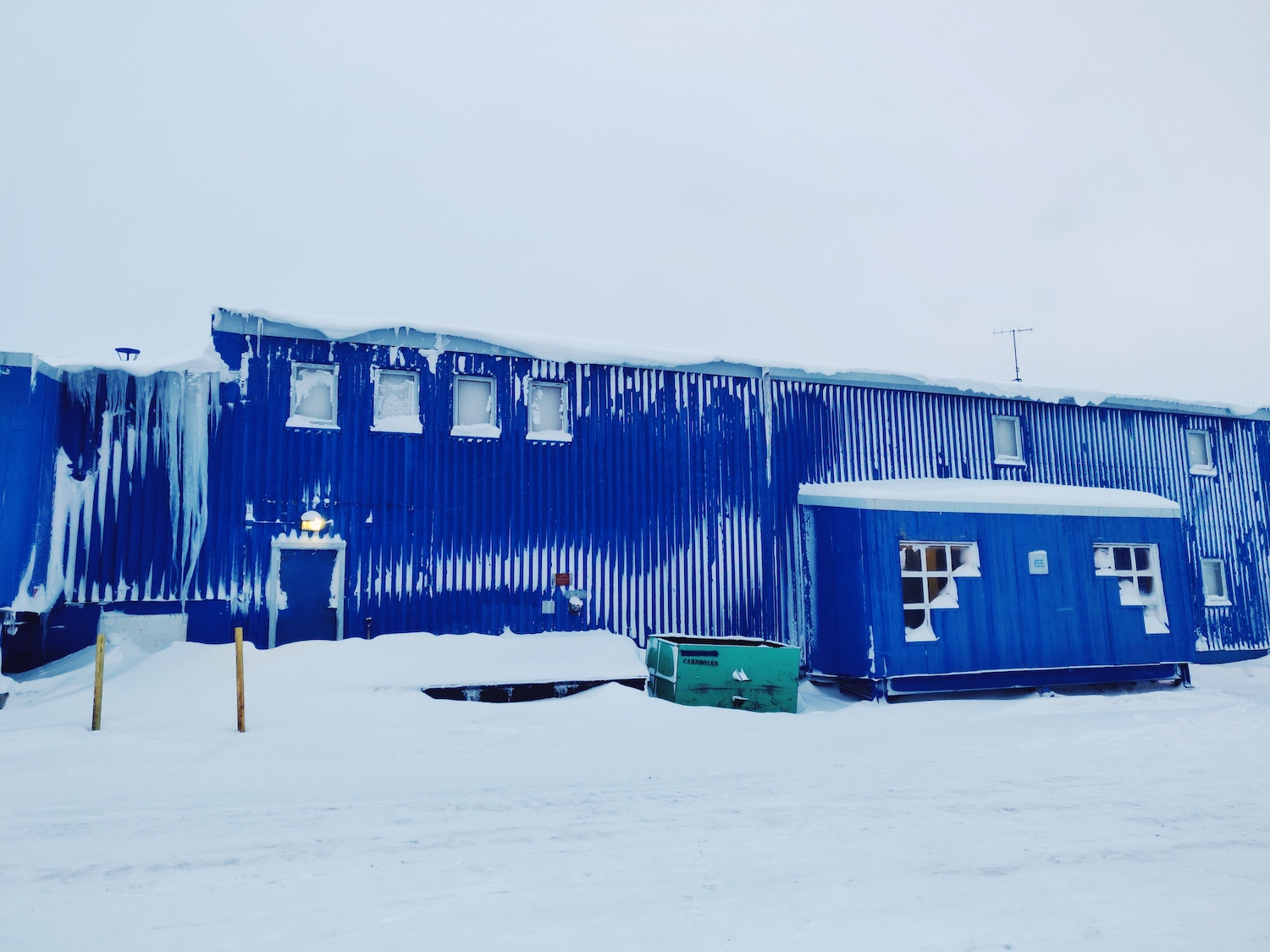 The central, blue Building 155 at McMurdo Station