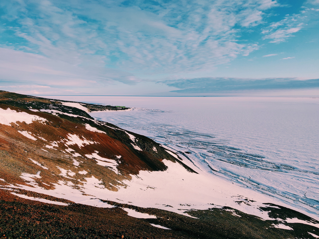 View of sea ice by McMurdo Station with Kiwi station Scott Base in the distance