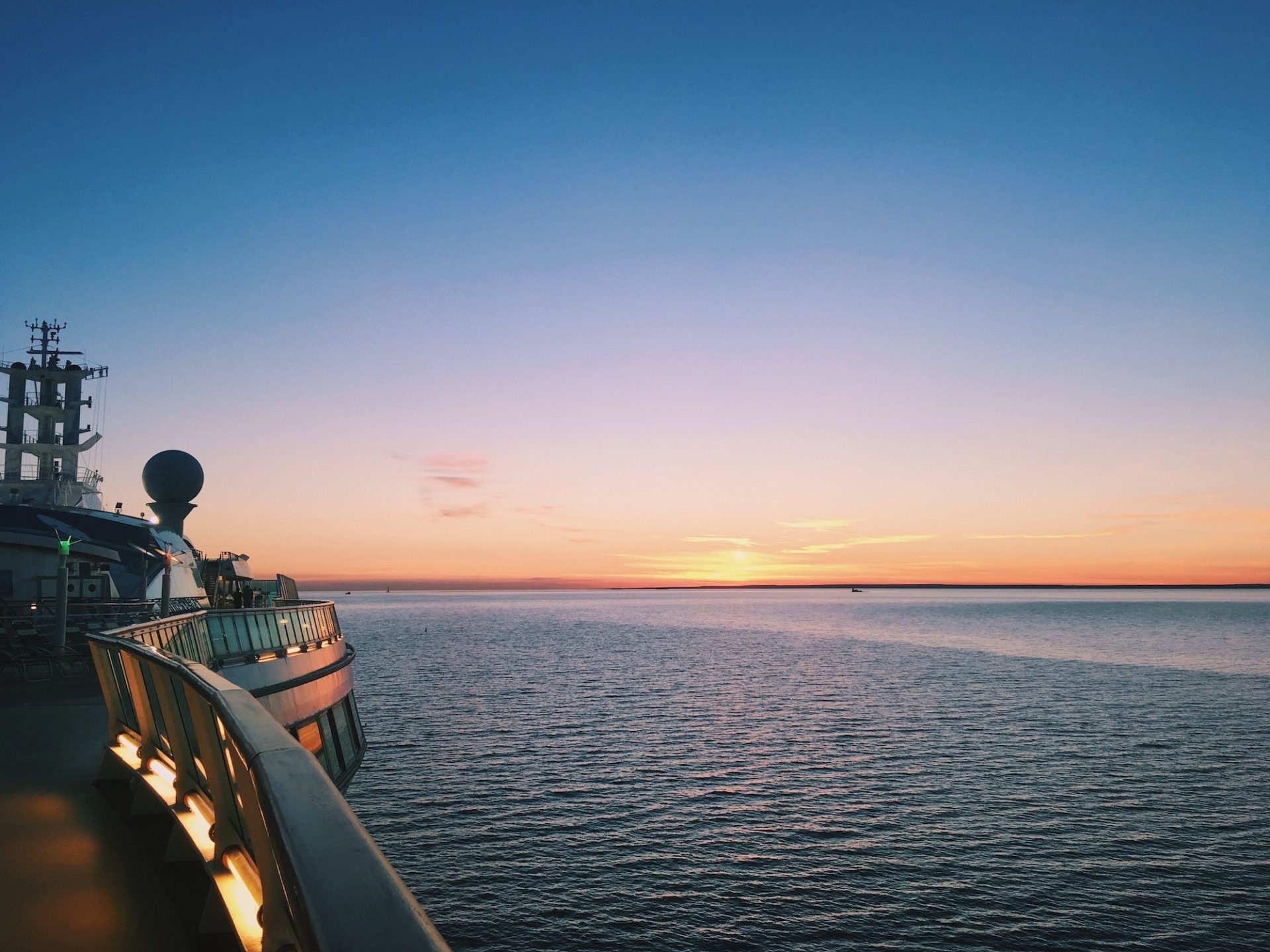 Top deck of cruise ship at sea during sunset
