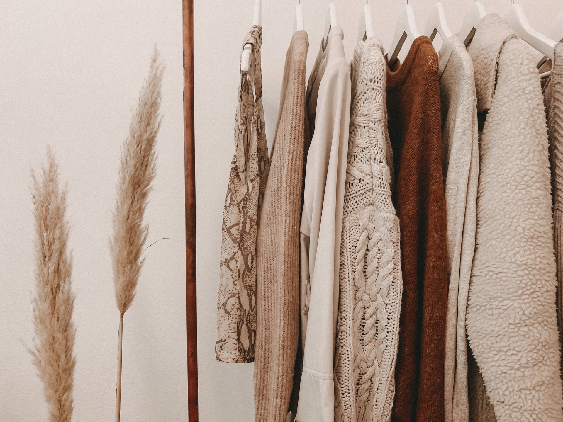 neutral toned clothing on display rack
