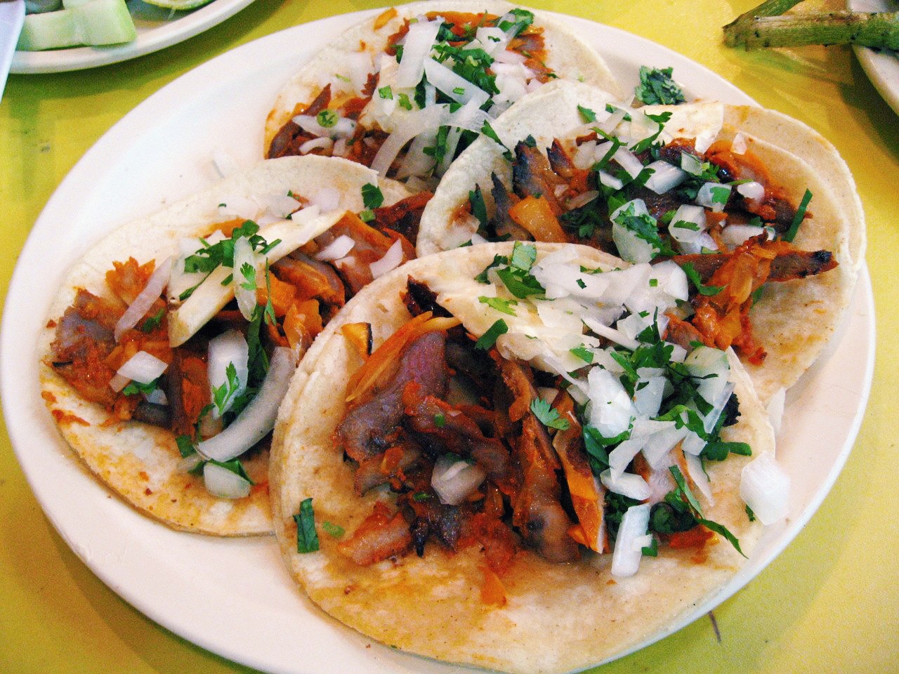 Four tacos al pastor with onions and cilantro at El Fogon tacqueria in Playa del Carmen