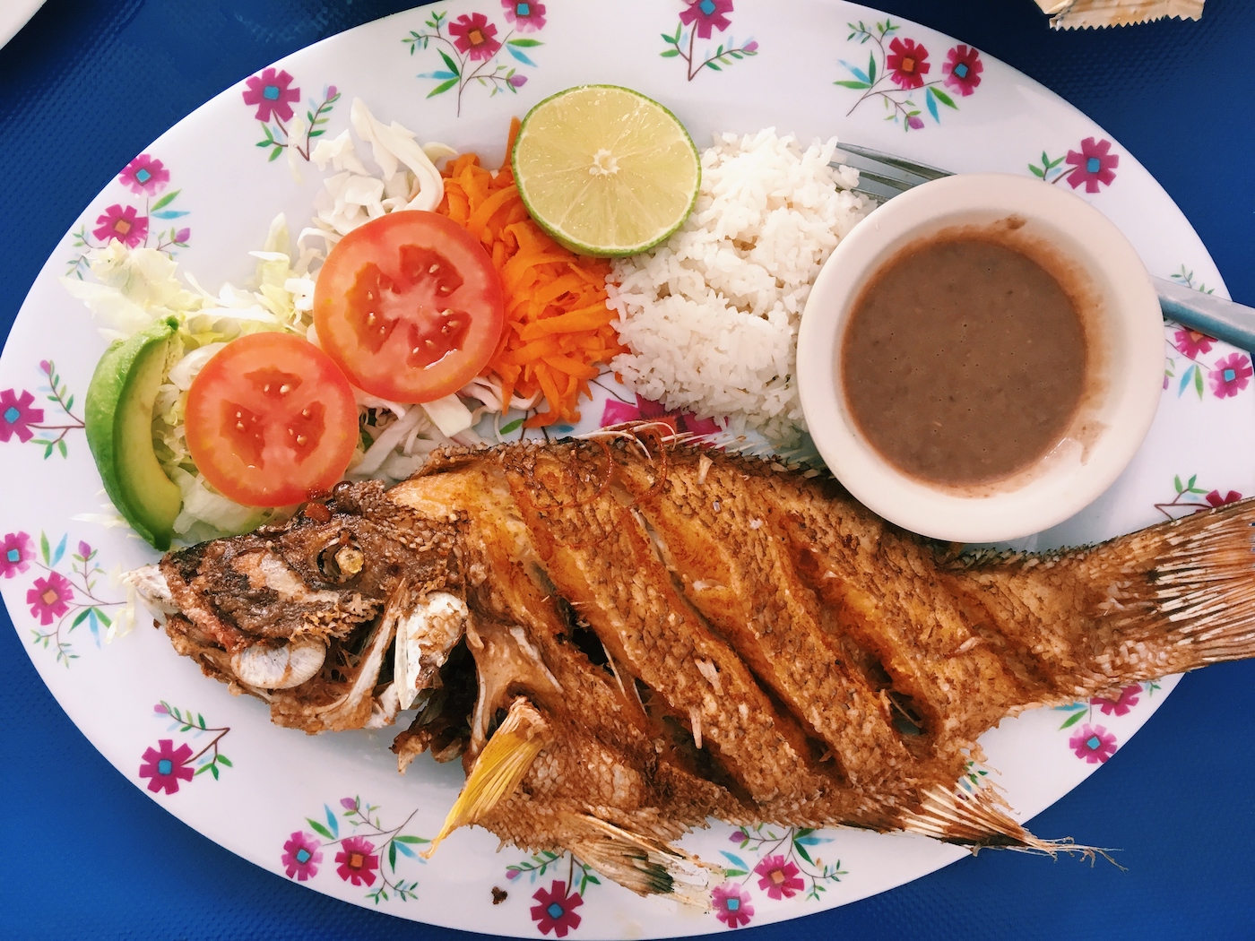 Fried fish with a small side salad of lettuce and tomatoes, beans, and rice at El Pirate in Playa del Carmen