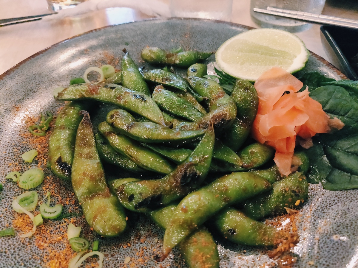 Edamame soy beans seasoned with powder spices and lime, served with soy sauce and ginger at Japanese fusion restaurant UNO in Playa del Carmen