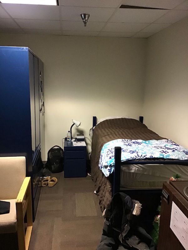 Inside McMurdo Antarctica dorm room: bed, chair, drawer, and wardrobe closet