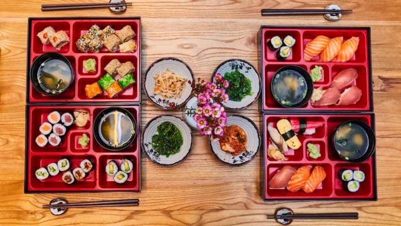 japanese food displayed in red lacqured boxes