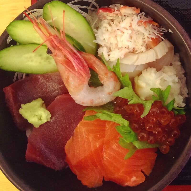 popular japanese food kaisendon with colorful ingredients: salmon roe, salmon, shrimp, tuna, crab, and cucumber
