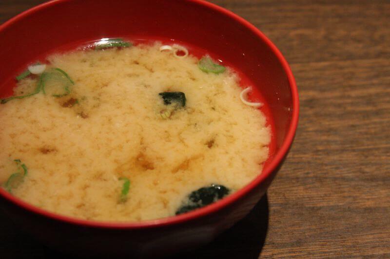 miso soup in a red bowl