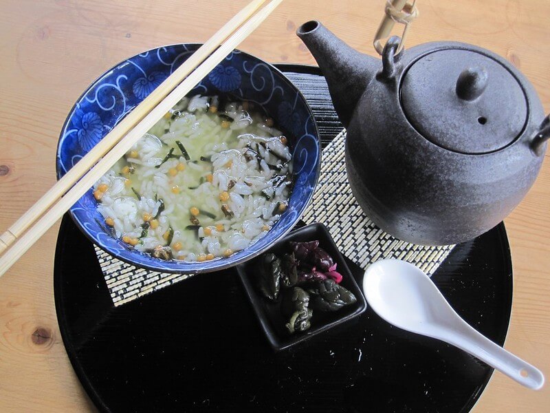 small bowl of rice with seasoning in a bowl covered with tea