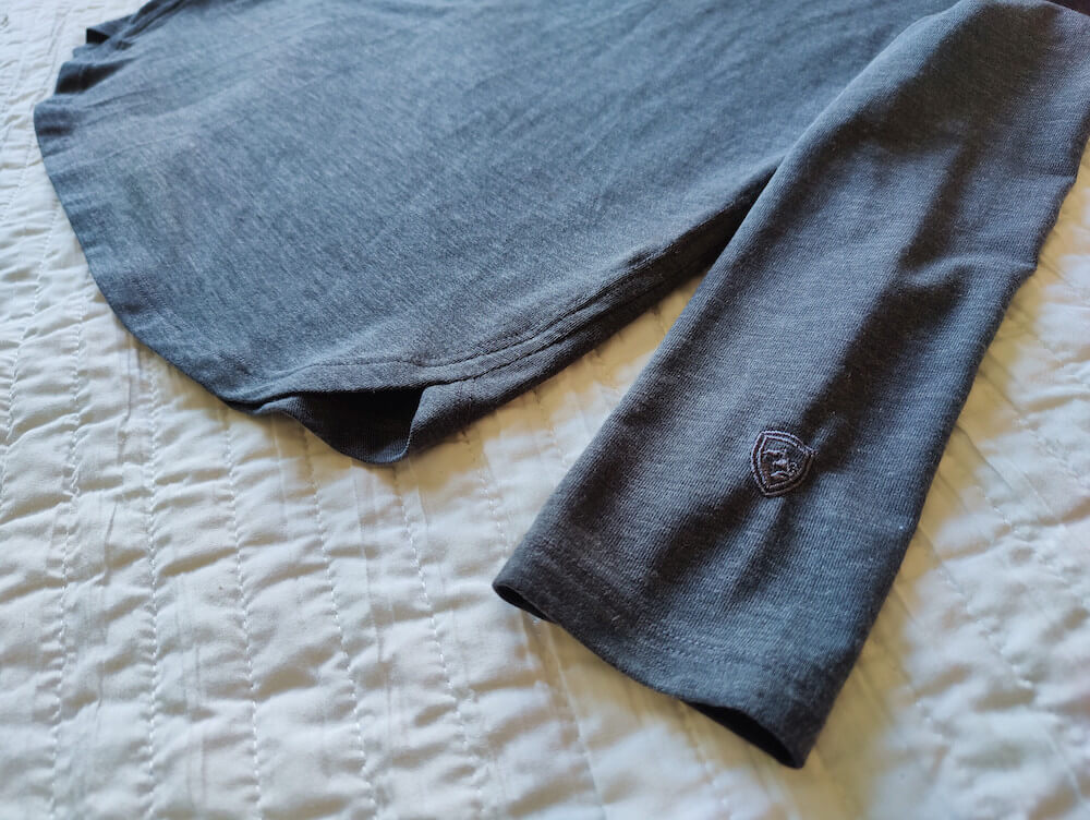 Bottom part of the Kuhl Konstance Sun Protection Long Sleeve showing the rounded hem and Kuhl logo on the sleeve
