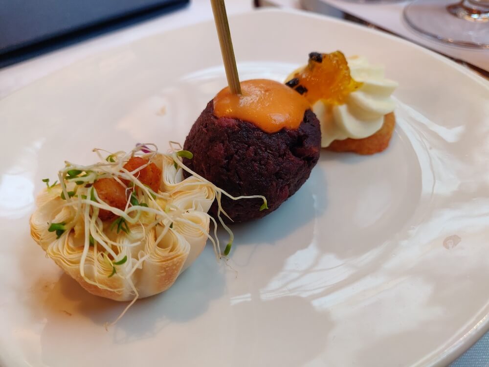 Christchurch Tramway Restaurant's Chef's Appetizers: three small appetizer options. Cream cheese and jam on a cracker, a savory tart with sprouts