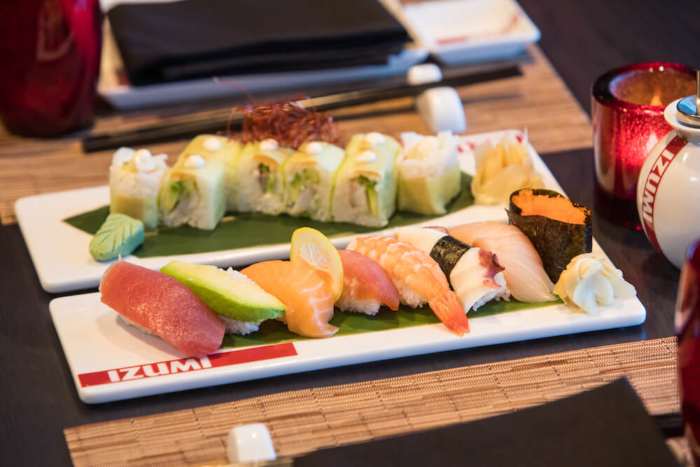 Royal Caribbean's Izumi featuring two rectangular plates with a roll of sushi and the other with nigiri sushi
