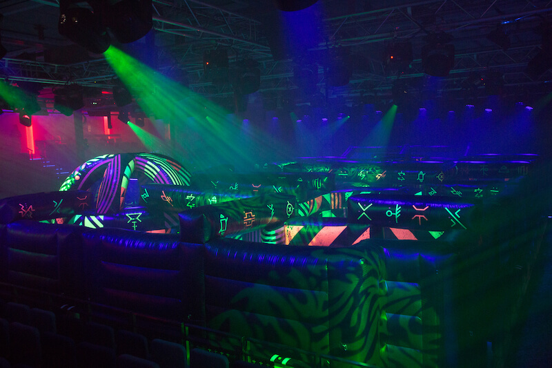 Glow in the dark laser tag onboard Symphony of the Seas. Includes special effect lighting and an inflatable course