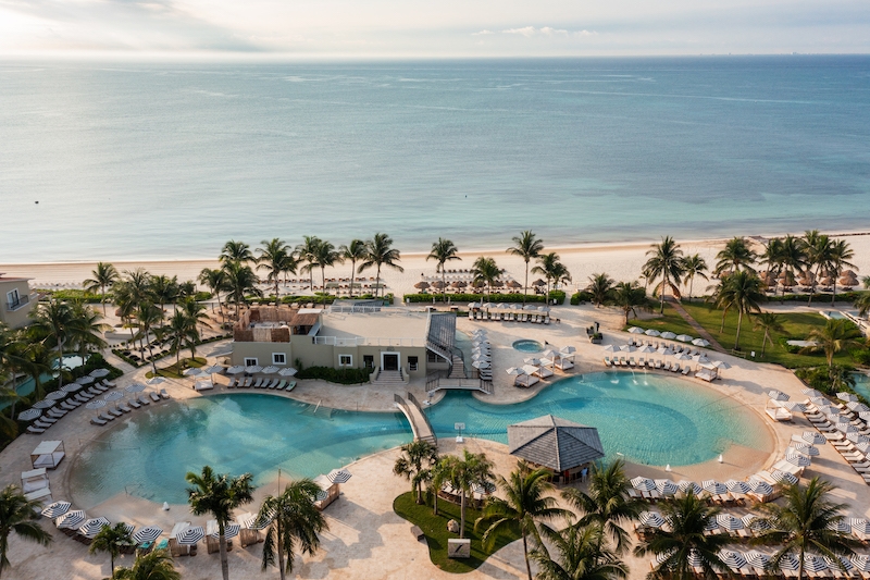 An aerial photo of Hyatt Zilara Riviera Maya all-inclusive adults-only resort in Playa del Carmen. The resort features a large lagoon pool, palm trees, and is located on the beach