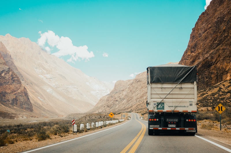 A truck driving on a mountainous road