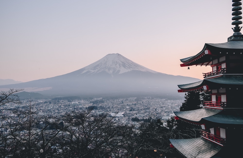 Image of pagoda on the right, city in the midground, and Mt. Fuji in the background