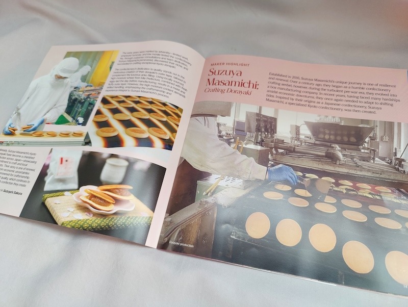 A culture guide from the Sakuraco box opened to a page with pictures of dorayaki and details about the maker, Suzuya Masamichi
