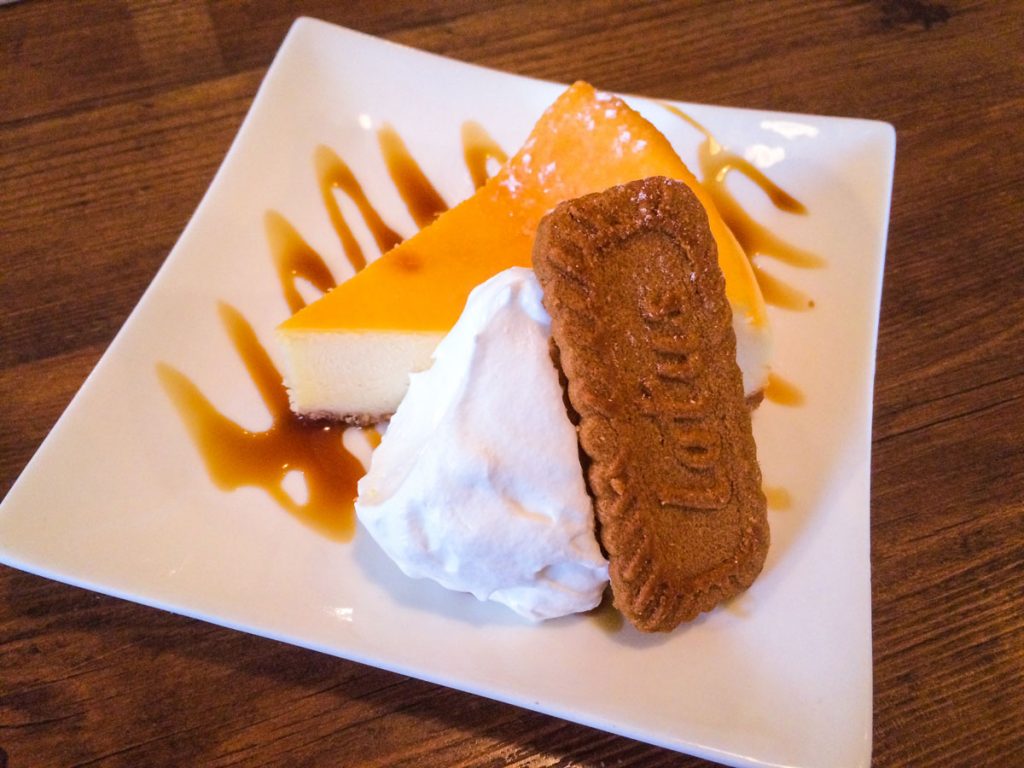 cheesecake with whipped cream and biscuit