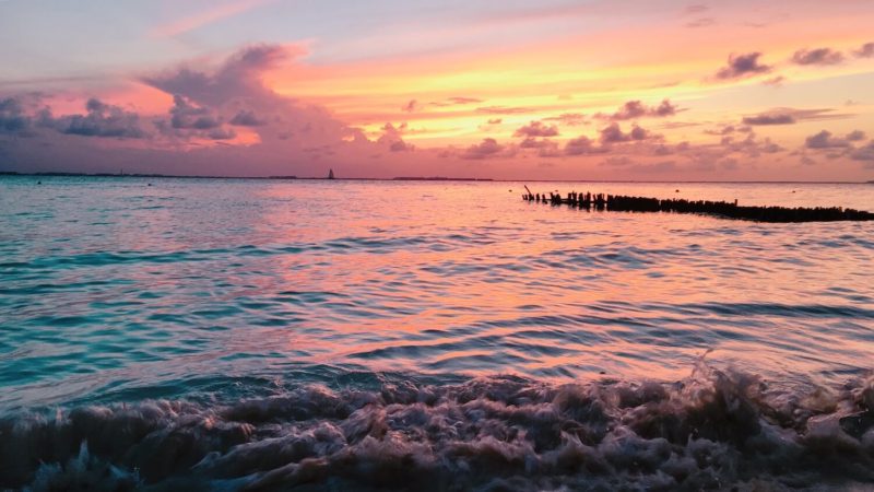 pink and yellow beach sunset at Playa Norte in Isla Mujeres, Mexico