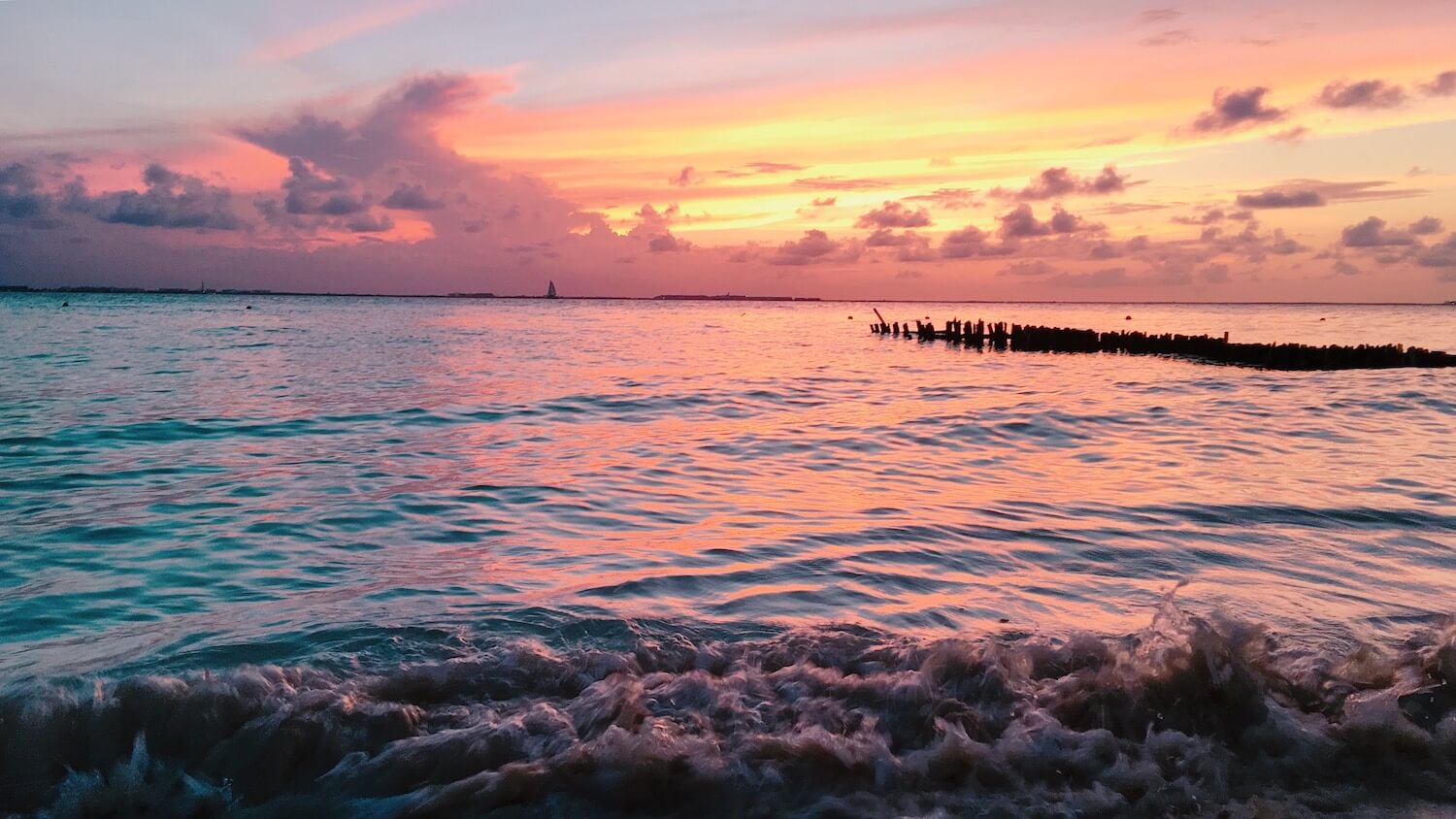 pink and yellow beach sunset at Playa Norte in Isla Mujeres, Mexico