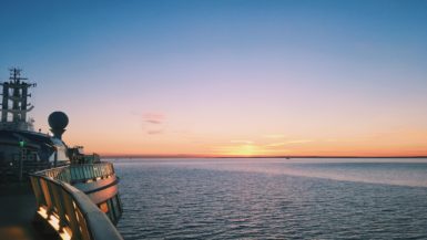 Top deck of cruise ship at sea during sunset