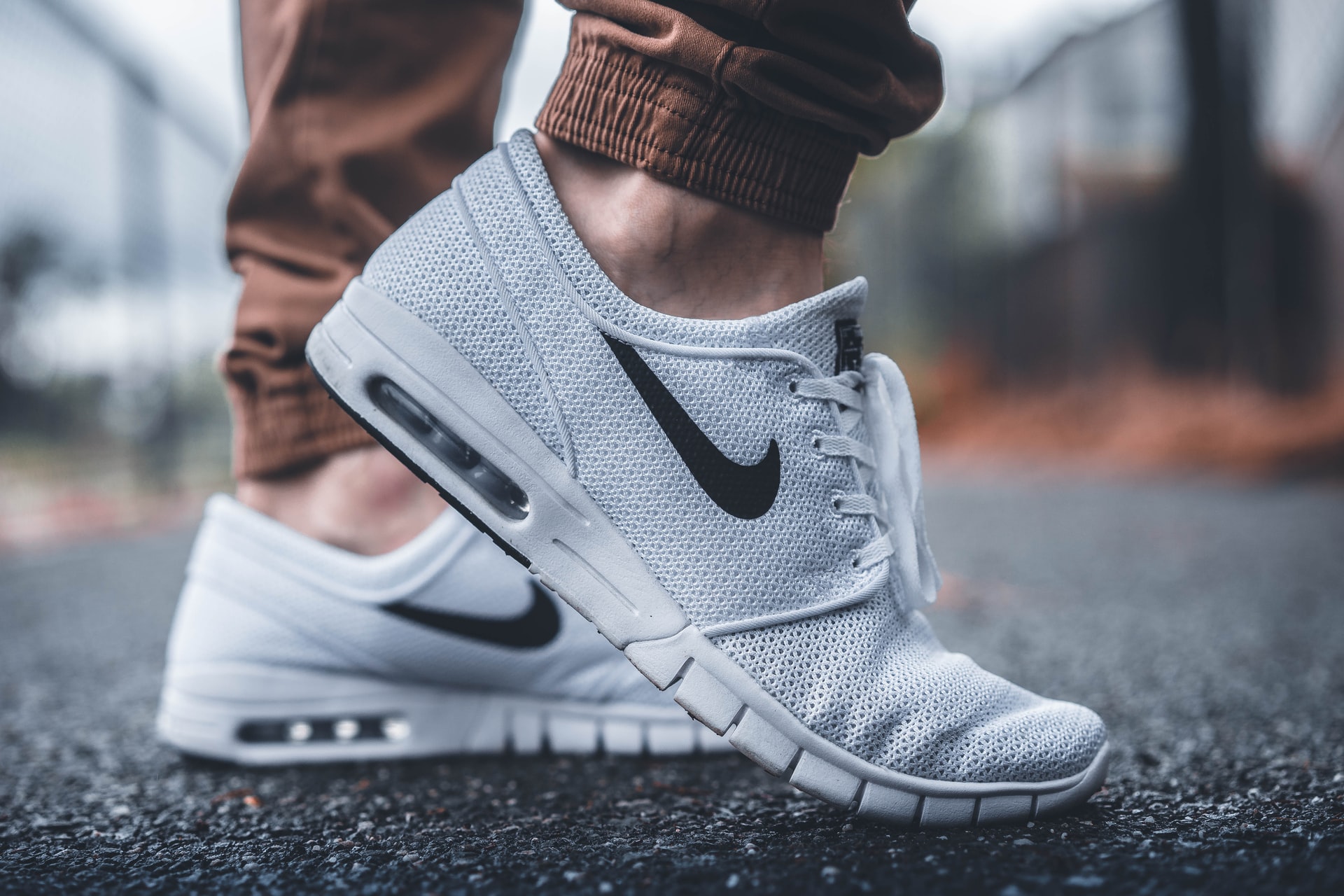man wearing white nike shoes