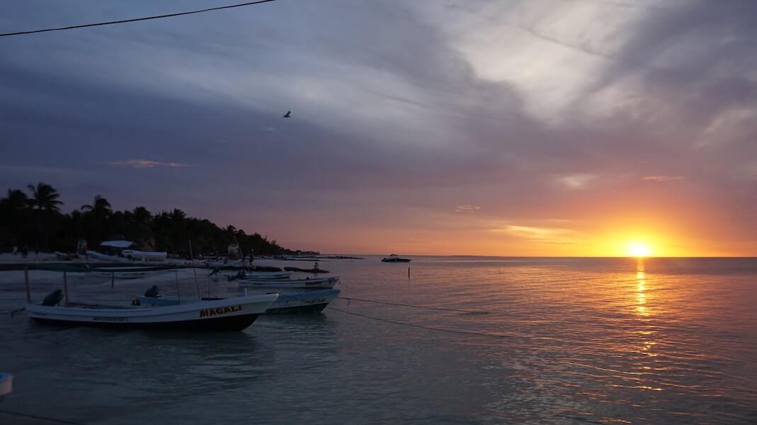 tied fishing boat at sunset in Holbox, Mexico