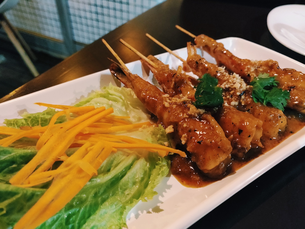 Shrimp skewers cooked in peanut sauce served with lettuce and shredded carrots from Po Thai restaurant in Playa del Carmen