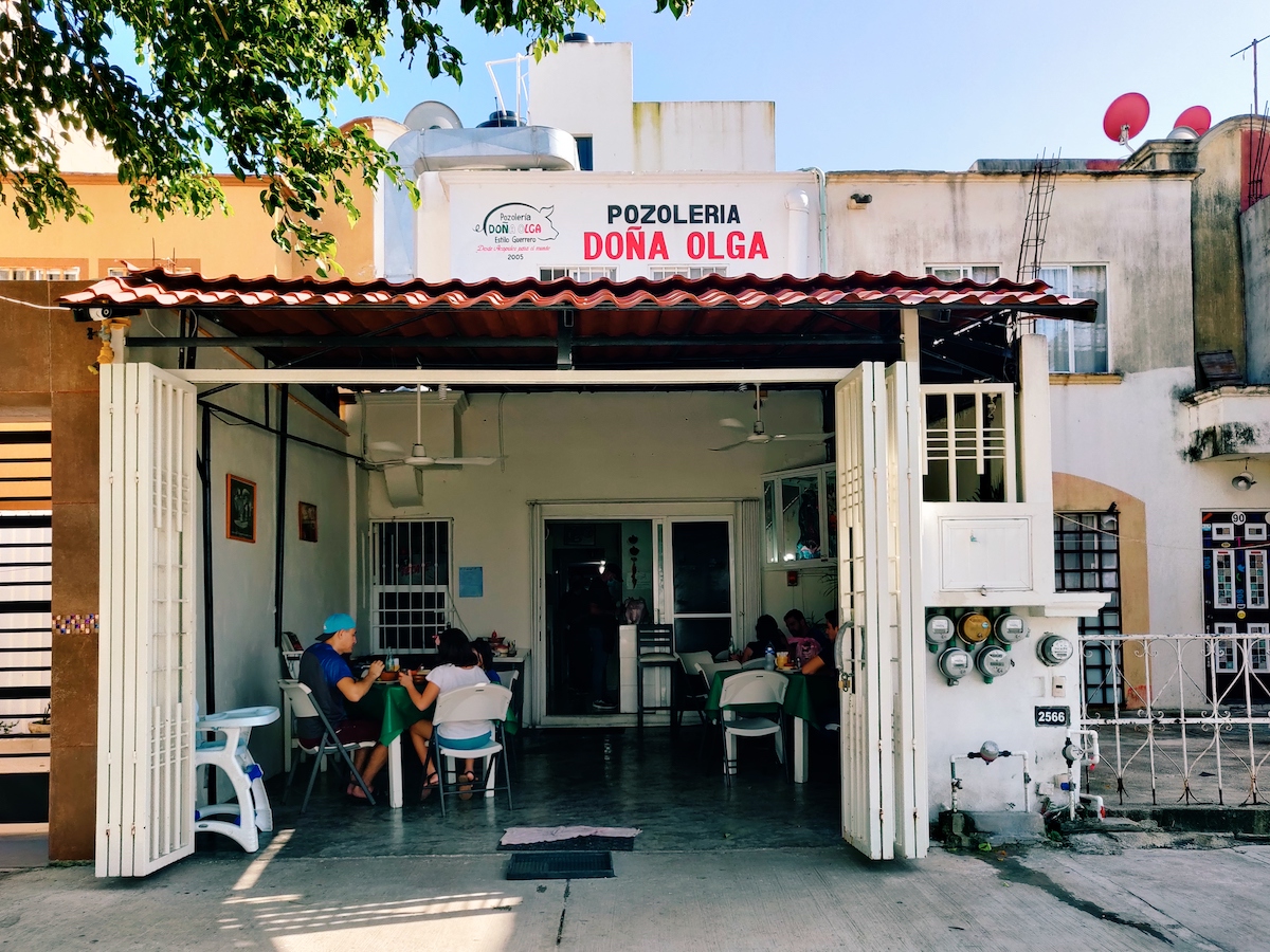 Pozoleria Dona Olga restaurant in Playa del Carmen with several small tables and patrons eating