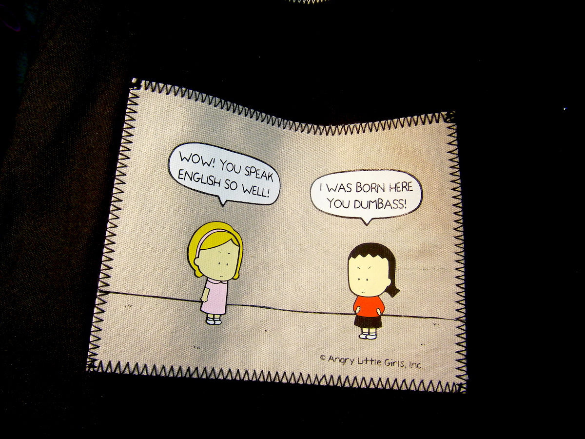 comic of white girl telling asian girl that her English is so good and the Asian girl responding, "I was born here, you dumbass!"