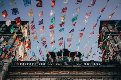 colorful paper decorations lined between buildings
