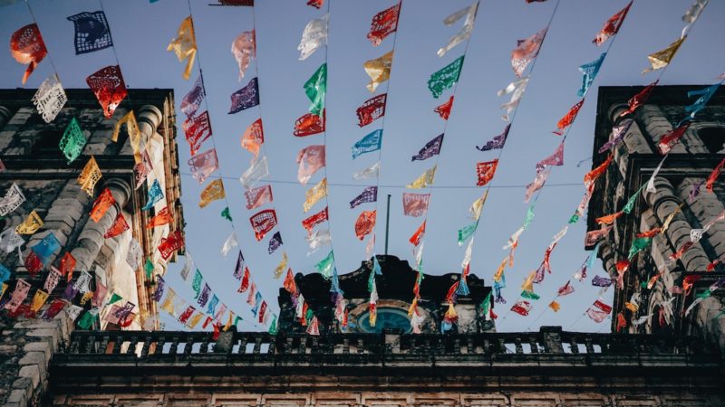 colorful paper decorations lined between buildings