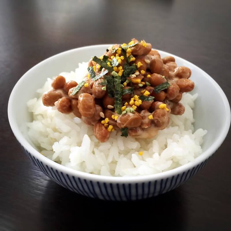 common japanese breakfast food natto served over a bowl of rice