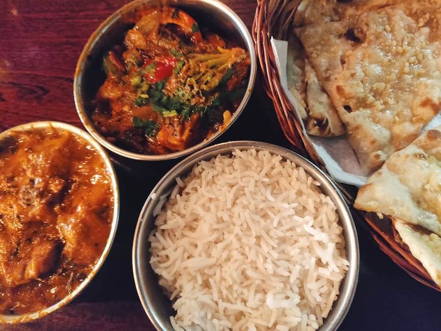 Tiffin tins of murgh makhani, kadai veg, and basmati rice with naan bread from Mumbaiwala Indian Street Kitchen in Christchurch