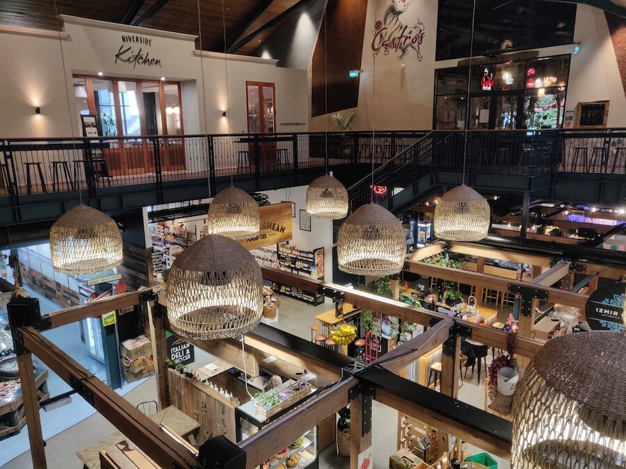 Interior view of Riverside Market from the second floor overlooking various shop stalls
