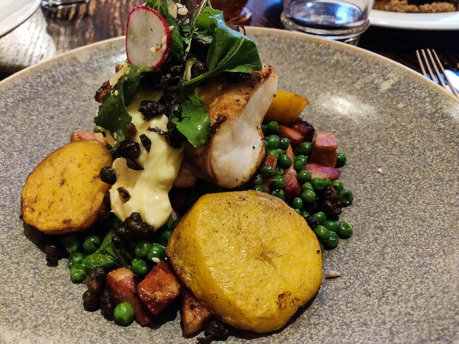 Pan-fried monkfish from Twenty Seven Steps accompanied with roasted potatoes, peas, and bacon bits