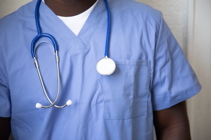 A nurse in scrubs wearing a stethescope