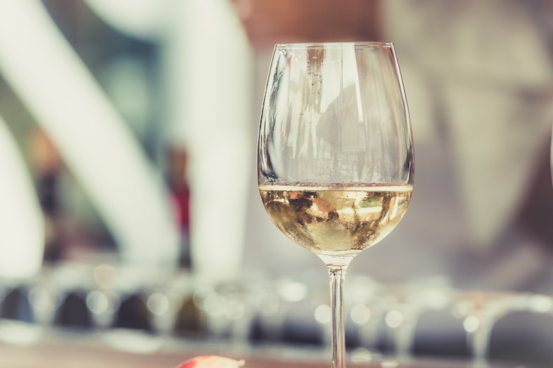 A wine glass with white wine