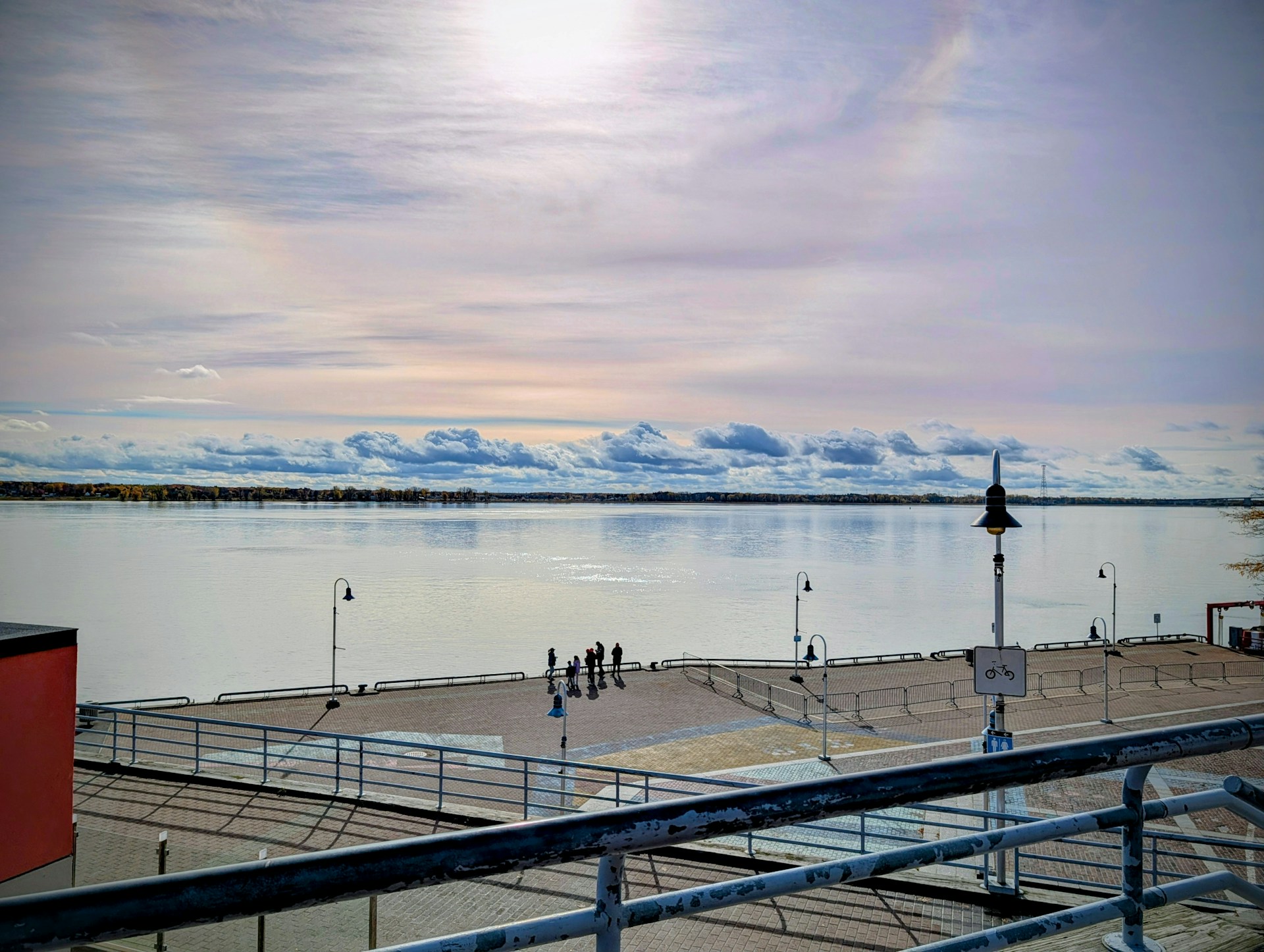 A pier with visitors looking out toward the water